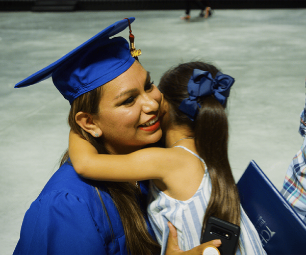 Erlinda at Graduation Hugging Her Daughter