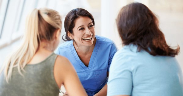 nurse speaking to patients